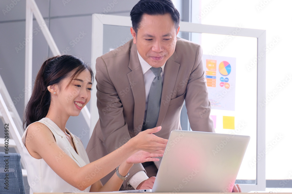Businessman and female employee sitting and working happy smile business idea. Businessman and female employee sitting and working happy smile business idea.