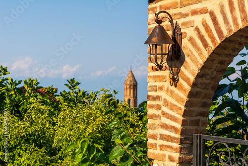 Arched wall with an old lamp in the Town of Sighnaghi in Georgia photo
