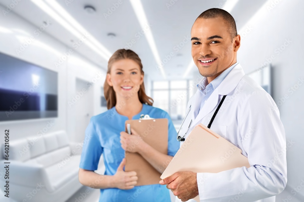 Team of happy doctors analyzing diagnosis in hospital Team of happy doctors analyzing diagnosis in hospital