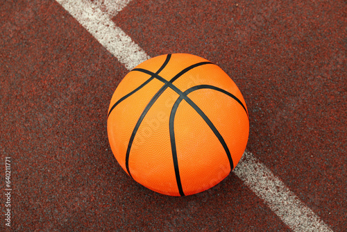 One basketball ball on playground rubber coating © Atlas