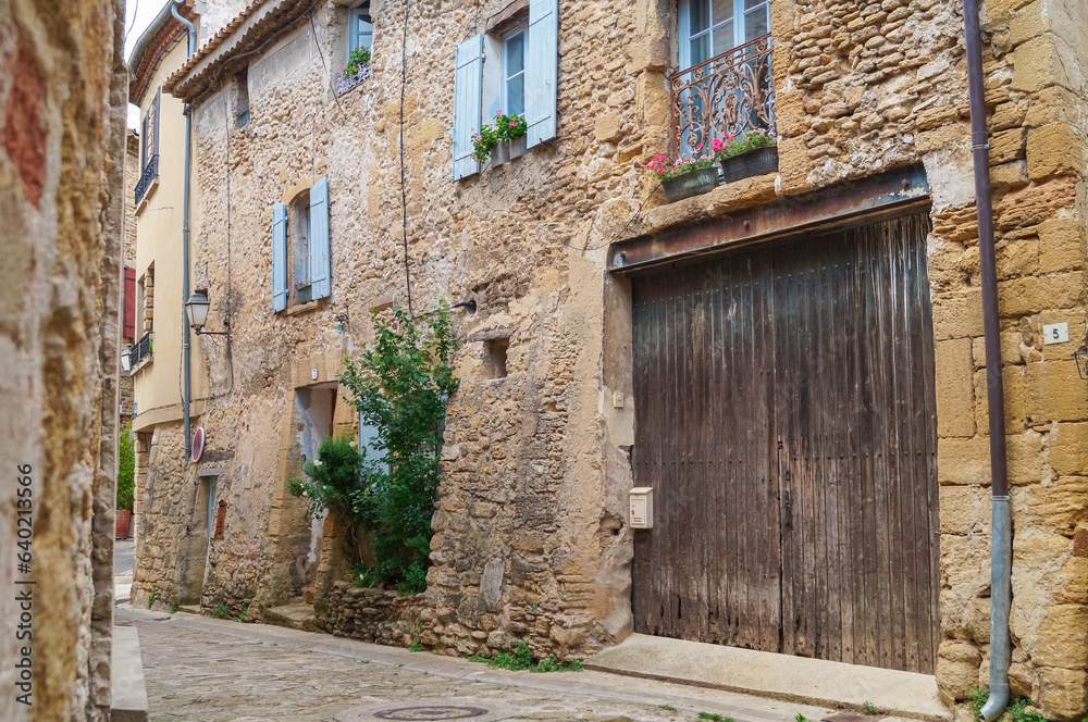 Ancient residential district with historic architecture and charming alleys of famous wine making village of Chateauneuf-du-Pape near Avignon, Provence-Alpes-Cote d'Azur, France. Medieval buildings