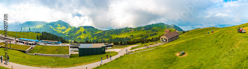 Leinwand Poster Large panorama of the beautiful mountainous landscape with the cogwheel railway station and the Regina Montium mountain chapel on the famous Mount Rigi Kulm, the Queen of the Mountains