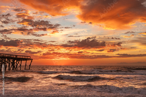 Sunrise over the Pawley's Island fishing Pier one week after half the pier was destroyed by Hurricane Ian