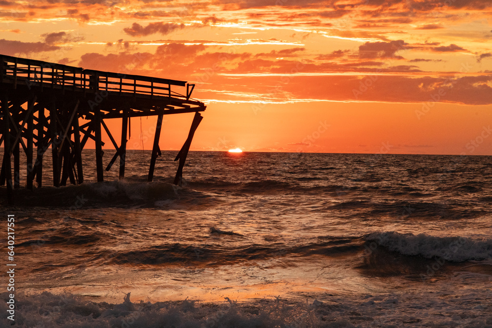 Sunrise over the Pawley's Island fishing Pier one week after half the pier was destroyed by Hurricane Ian