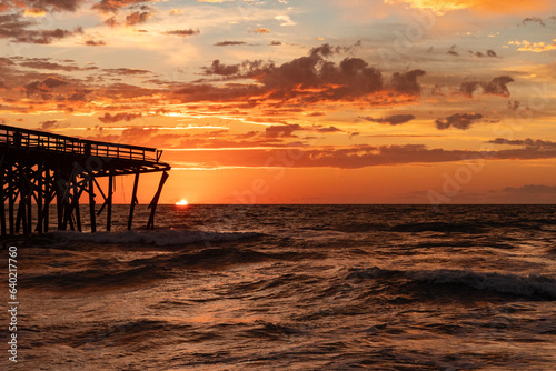 Sunrise over the Pawley's Island fishing Pier one week after half the pier was destroyed by Hurricane Ian © John McAdorey
