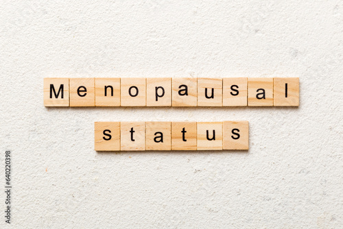 menopausal status word written on wood block. menopausal status text on cement table for your desing, concept