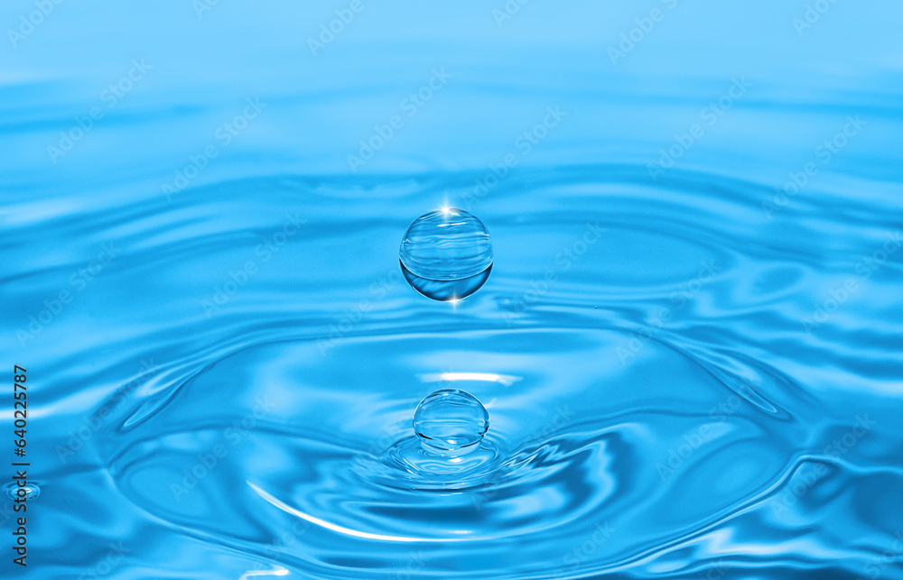 Clear aqua water droplet splashing in concentric circles, capturing refreshing purity. Clear aqua water droplet splashing in concentric circles, capturing refreshing purity.