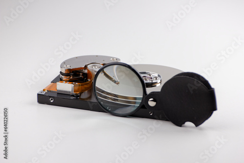hard drive and magnifying glass, representing the process of searching and saving data