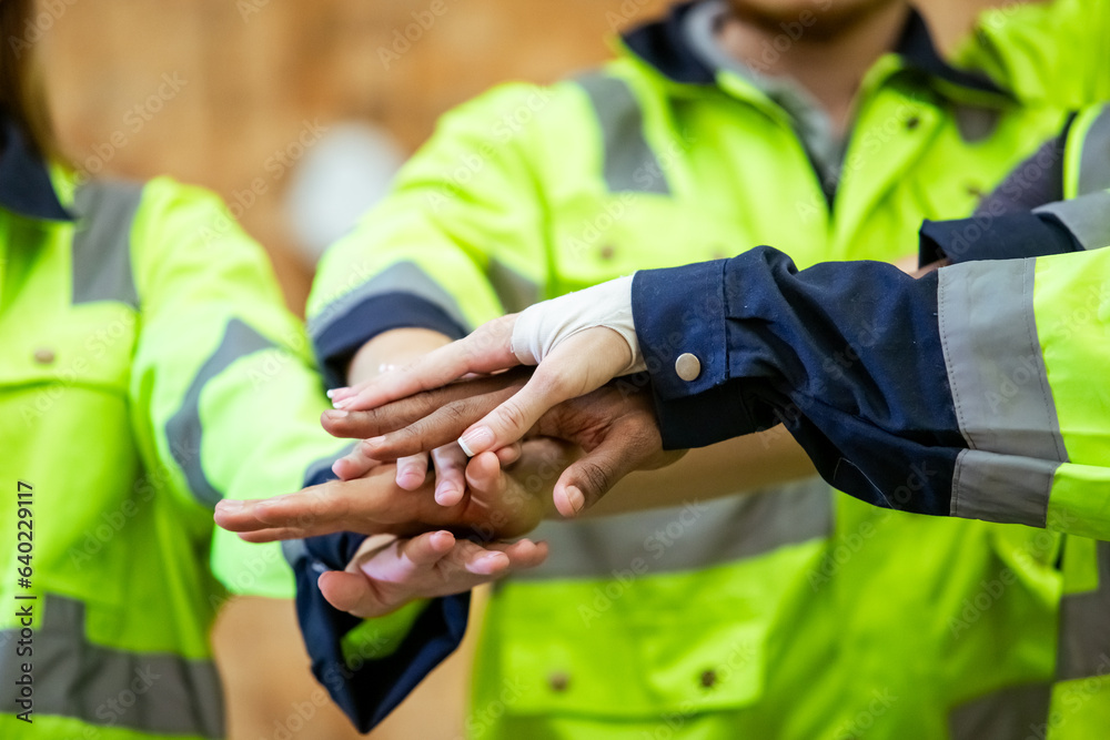 Fototapeta premium Team engineering and foreman connect join hands successful projects, Stack of hands, Teamwork partner concept. warehouse diversity worker handshake agreement.
