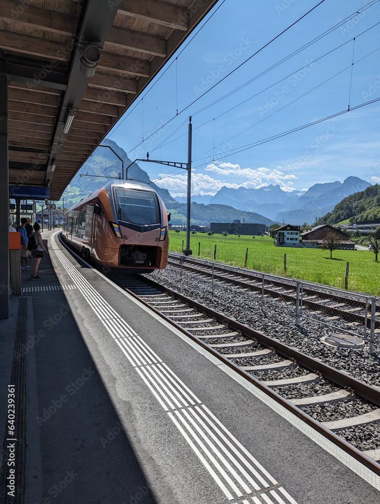 Naklejka premium train on railway station scenic Switzerland