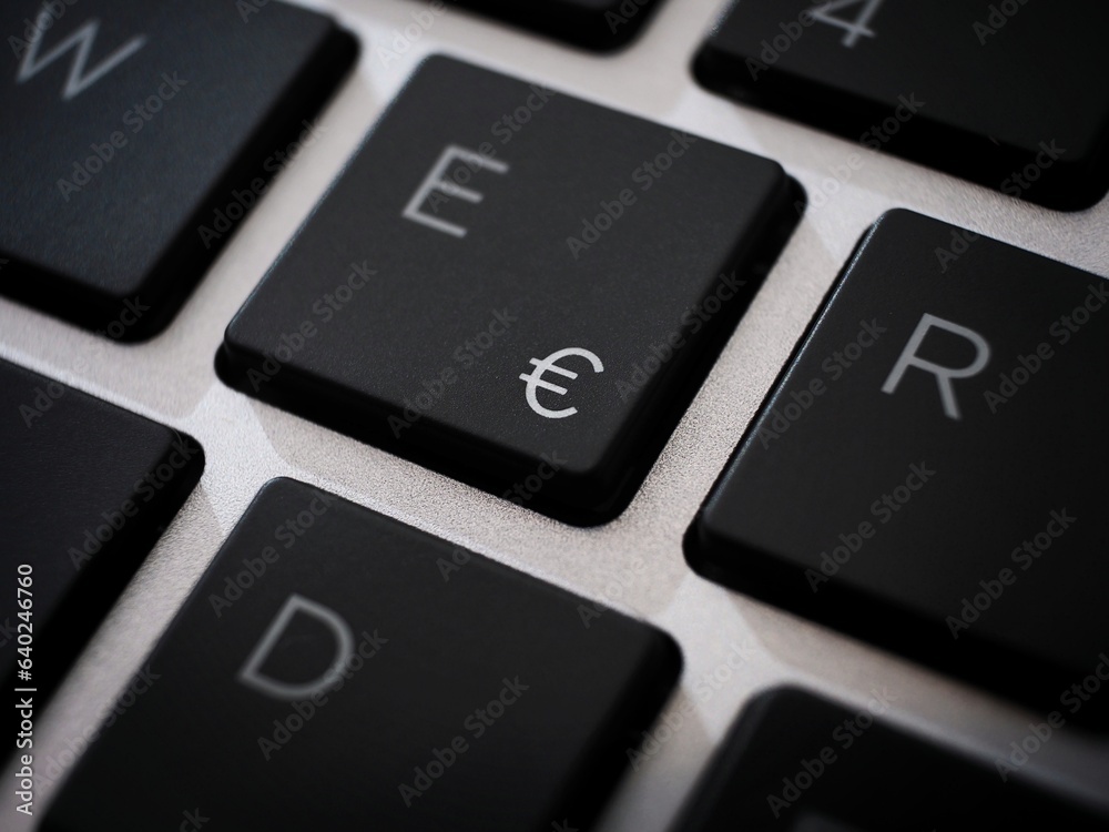 Black € euro sign key macro on a laptop keyboard