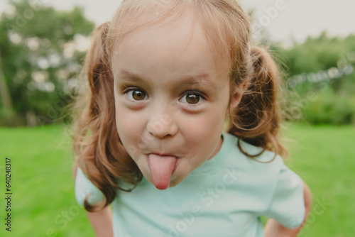 Konstfotografi Funny laughing girl teasing with tongue sticking out