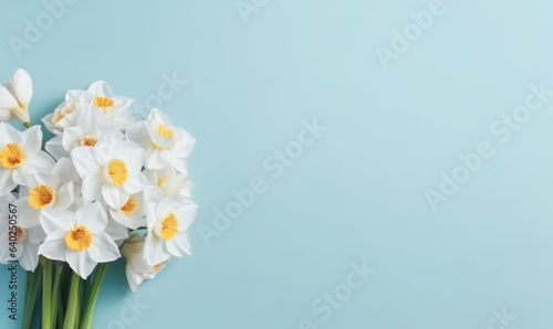 A narcissus flowers bouquet on a pastel blue background with empty copyspace. Mother's Day concept. Created by generative AI