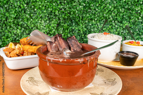 famous brazilian food dish, called feijoada, with cassava and white rice