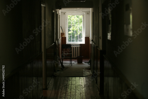 A dark corridor with a window.