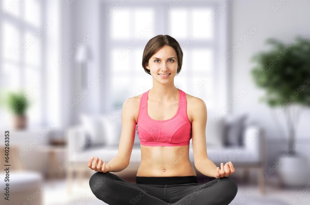 Young woman meditating in yoga pose