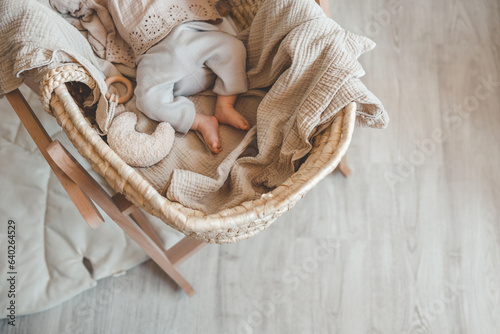 Foto Feet of a newborn baby in a cradle, top view, space for text