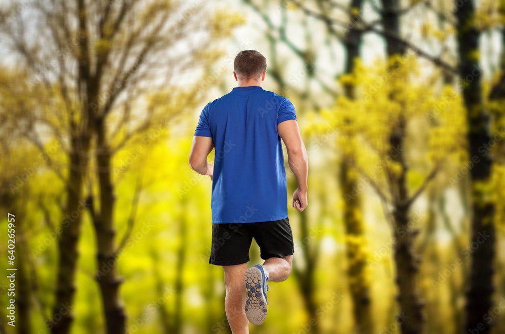 Motivated handsome athletic man jogging in park Motivated handsome athletic man jogging in park