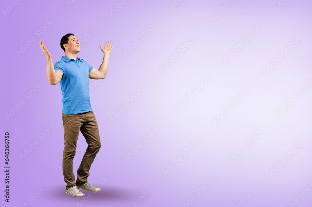 handsome young sporty man posing on color background