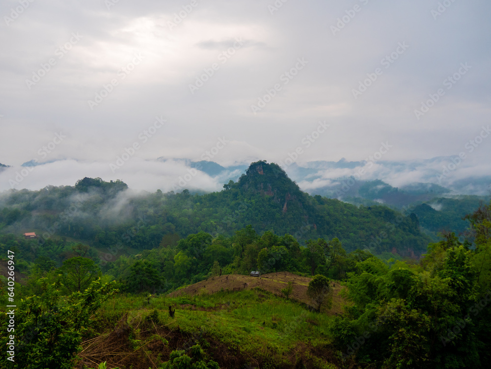 A beautiful scenic view with green mountains and fog at 