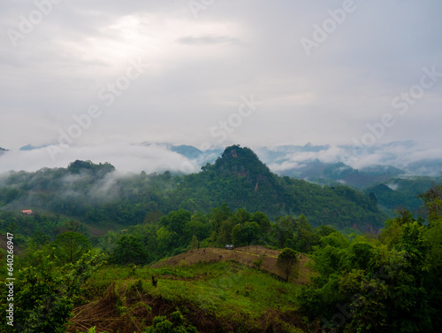 A beautiful scenic view with green mountains and fog at  Ban Jabo  Village in Mae Hong Son  Thailand.