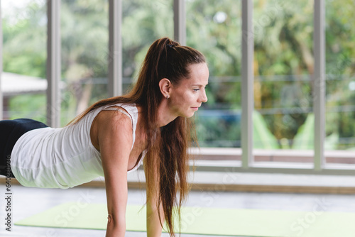 Caucasian woman exercising with exercise ball. Fitness girls flexing abdominal muscles with fit ball in gym room. Free Download Caucasian woman exercising with exercise ball. Fitness girls flexing abdominal muscles with fit ball in gym room. - GFXLoad