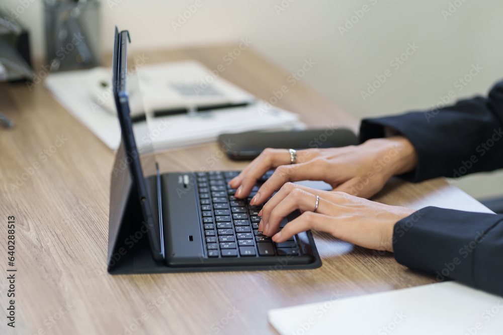Creative woman typing on empty white screen tablet. Creative woman typing on empty white screen tablet.