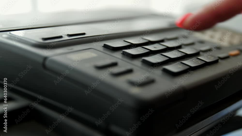 The girl picks up handset wired phone and dials 911. A woman office worker calls emergency services by phone. Call the police, ambulance or fire department. The girl picks up handset wired phone and dials 911. A woman office worker calls emergency services by phone. Call the police, ambulance or fire department.