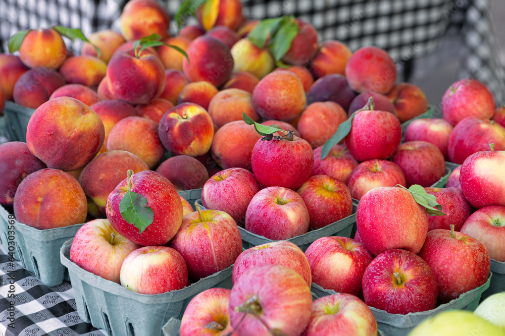 Fresh apples and peaches at a local farmer's market Fresh apples and peaches at a local farmer's market