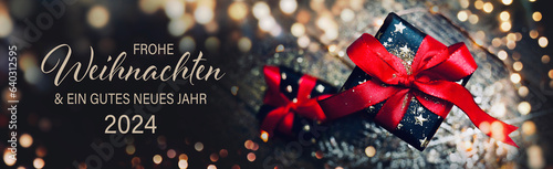 Christmas greeting card with German text Frohe Weihnachten und ein gutes neues Jahr 2024  - Gift box with red bow and bokeh lights