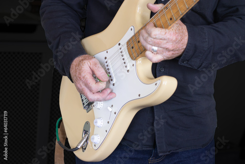 Electric guitar playing close up.