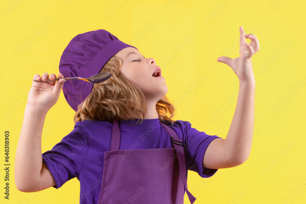 Funny kid chef cook with spoon, studio portrait. Child in cook uniform. Chef kid isolated on yellow background. Cute child to be a chef. Child dressed as a chef hat. Funny kid chef cook with spoon, studio portrait. Child in cook uniform. Chef kid isolated on yellow background. Cute child to be a chef. Child dressed as a chef hat.