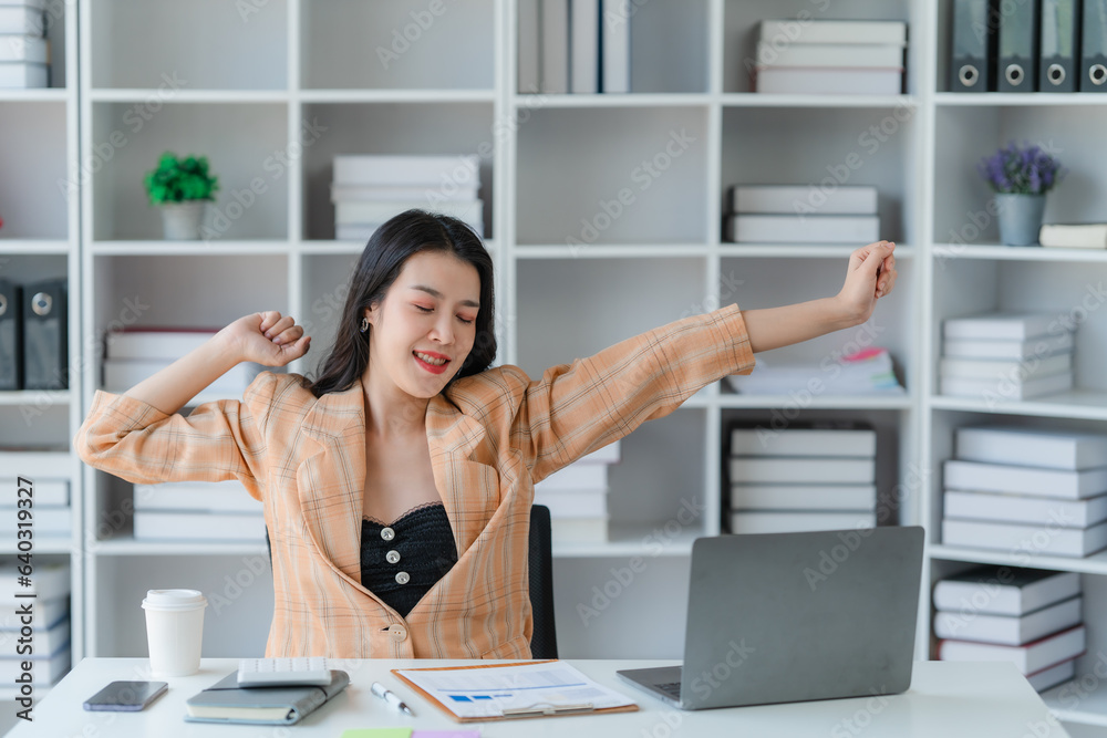 Cheerful business lady working on laptop in office, Asian happy beautiful businesswoman in formal suit work in workplace. Attractive female employee office worker smile. Cheerful business lady working on laptop in office, Asian happy beautiful businesswoman in formal suit work in workplace. Attractive female employee office worker smile.