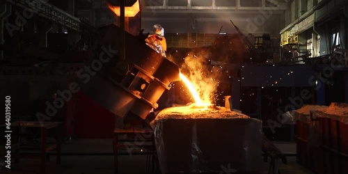 Liquid iron molten metal pouring in container, industrial metallurgical factory, foundry cast, heavy industry background