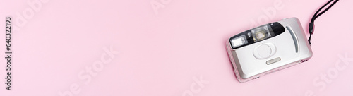 silver film camera banner on pink background top view