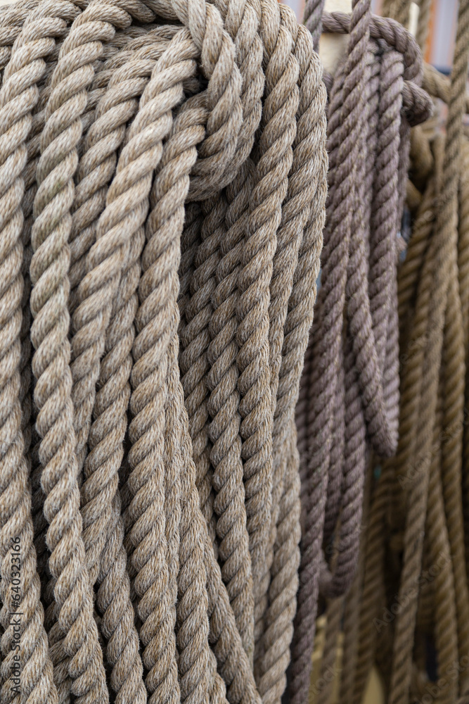 Close-up of three old rope coils on ship cleats, focus on the front.
