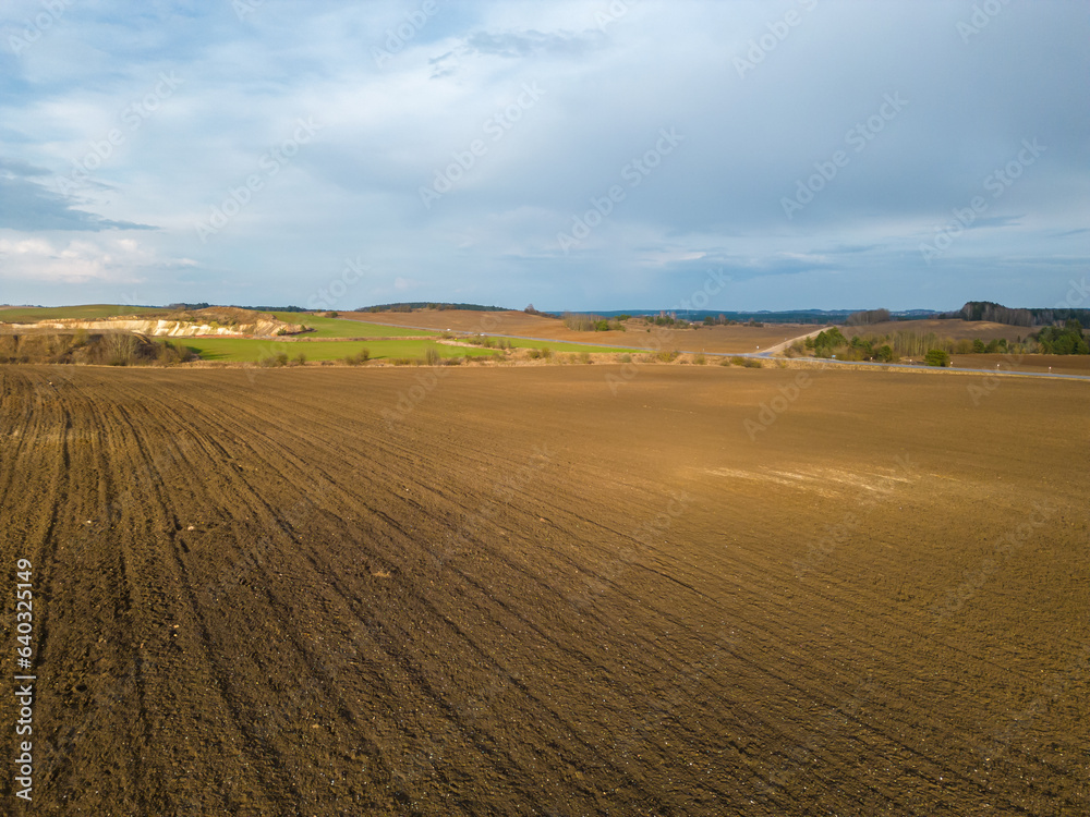 Drone photo of a plowed fields at sunset. Aerial view of a farmer's field. Abstract patterns and straight lines on agricultural land. Drone photo of a plowed fields at sunset. Aerial view of a farmer's field. Abstract patterns and straight lines on agricultural land.