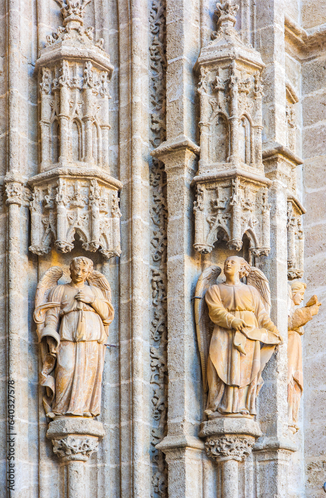 Sculptures of angels on a side of the Puerta de Palos door, also known as the Puerta de la Adoracion de los Magos door. Eastern facade of the Seville Cathedral. Seville, Andalusia, Spain.