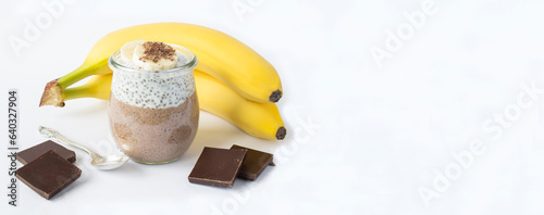 Obraz na plátne Chocolate pudding with chia seed and banana in the glass jar on the white background