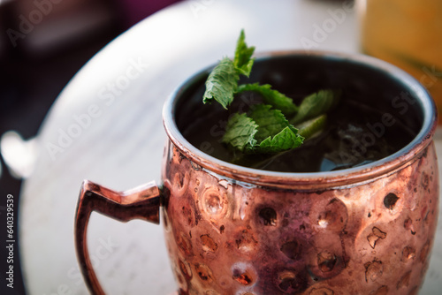 Canvas Print Alcoholic cocktail with a slice of lime, mint leaves, cinnamon, ginger