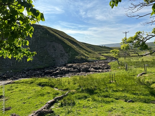 Landscape with  the almost dry riverbed of the Wharfe, as it descends  from the hills near, Hubberholme, UK photo