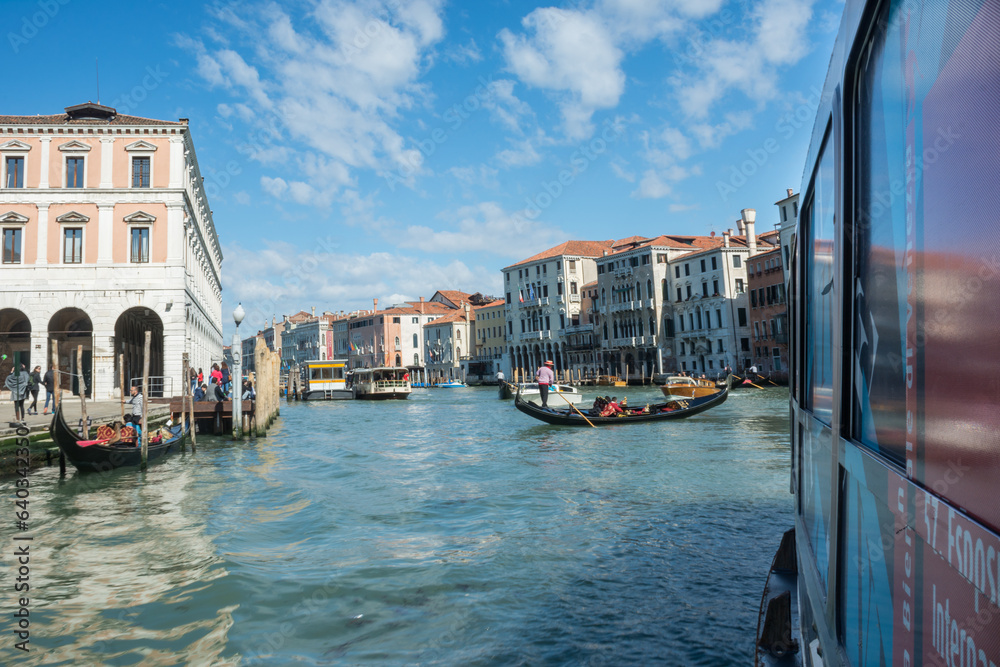 Obraz premium gondola crossing a canal in venice