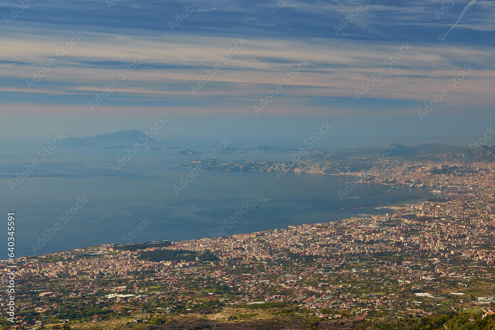 Panoramic view from volcano Mount Vesuvius on the bay of Naples, Province of Naples, Campania region, Italy, Europe. Looking at the island of Capri and Mediterranean coastline on a cloudy day.