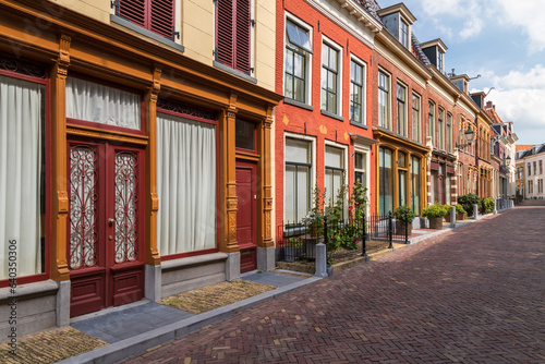 Narrow street with historic houses and beautiful facades in the center of the city of Leeuwarden in Friesland. photo