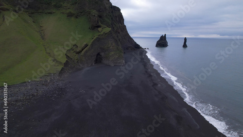 The Reynisfjara Black sand beach, Halsanefshellir cave, basalt columns and sea stacks at Vik i Myrdal in Iceland. photo