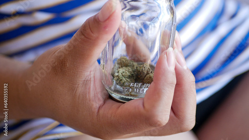 Jar of weed in hand