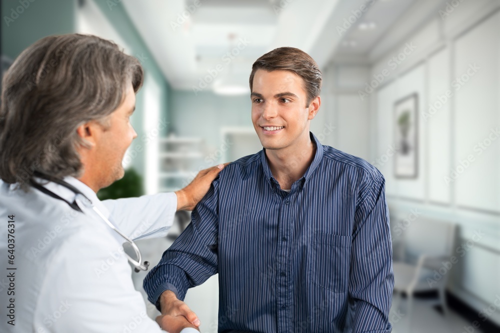 Young doctor consulting patient in modern clinic Young doctor consulting patient in modern clinic