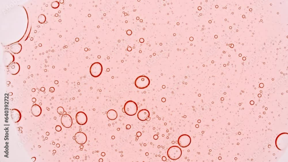 Clear liquid Cosmetic Product Transparent Gel Fluid spreading on a white background. Gel texture with bubbles, skin care product. Macro Shot of Natural Organic Cosmetics, Medicine. High quality 4k