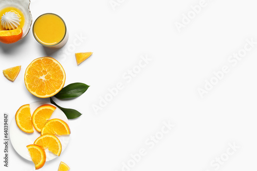 Glass of fresh orange juice and juicer on white background