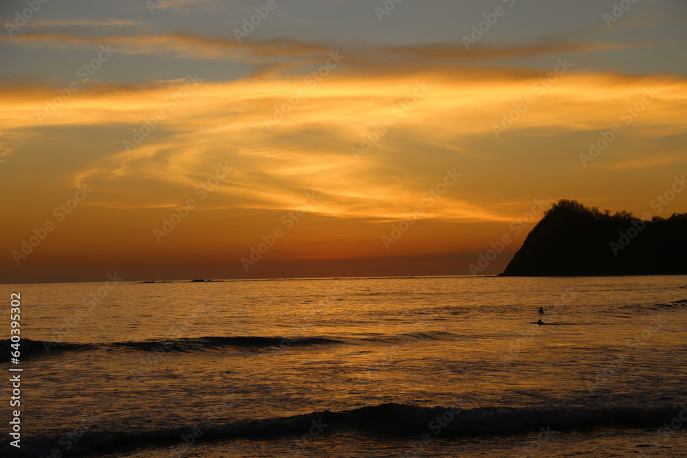 Sunset at Playa Nacional, Sámara. View of the shore  with horizon over the sea